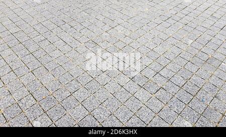 Steinweg. Pflastersteine auf Straßen und Gehwegen in der Altstadt. Pflaster Stein Material Hintergrund. Granit, Kopfsteinpflaster. Beton pav Stockfoto