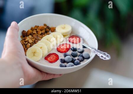 Gesundes Frühstück Haferbrei Haferbrei mit Erdbeeren, Banane, Heidelbeeren und Müsli Stockfoto
