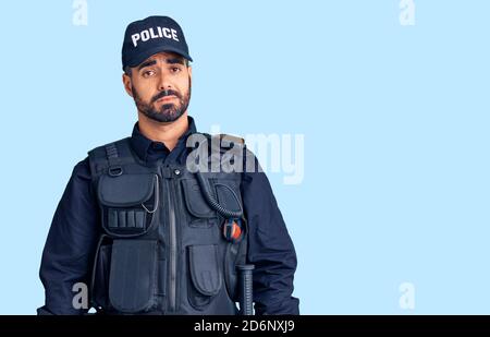 Junger hispanischer Mann in Polizeiuniform, müde und müde, erschöpft von Müdigkeit und Kater, faule Augen am Morgen. Stockfoto