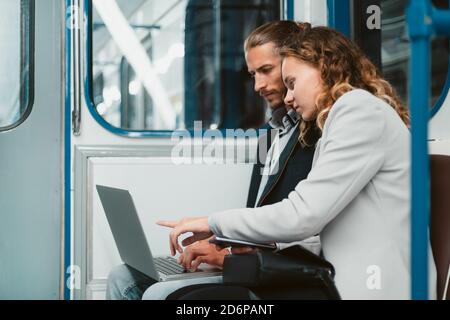 Schönes junges Paar, das in einem U-Bahn-Auto sitzt. Stockfoto