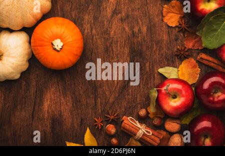 Thanksgiving Hintergrund, Lebensmittel Herbst Ernte Konzept. Rustikaler Tisch mit Äpfeln, Kürbissen, Nüssen, Trauben und Mais auf dunklem Tisch mit Kopierfläche, top vie Stockfoto