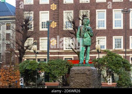Bergen, Norwegen - 12. Dezember 2015: Statue des Komponisten Edward Grieg mit Rikstelegraf und Rikstelefon Gebäude im Hintergrund. Bronzedenkmal im Abtrieb Stockfoto