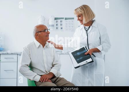 Senior Mann haben Beratung in der Klinik durch die Frau Arzt Stockfoto