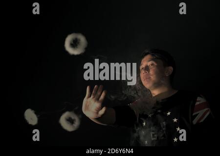 Ein Vape-Cloud-Performer zeigt einige seiner Tricks in einem Vape-Café in der Provinz Banten, Indonesien. Stockfoto