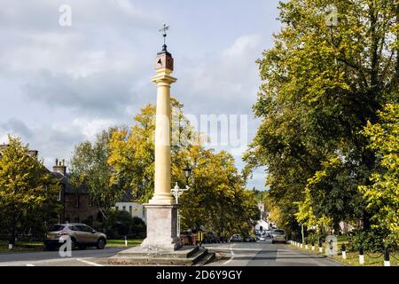 Hochkreuz aus dem 17. Jahrhundert mit Blick auf die von Bäumen gesäumte Straße im Herbst. Boroughgate, Appleby-in-Westmorland, Eden District, Cumbria, England, Großbritannien Stockfoto