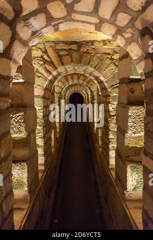 Tunnel mit Steinbögen in den Katakomben von Paris, Frankreich Stockfoto