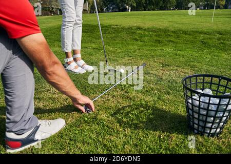 Junge kaukasische Frau, die einen Golfunterricht nimmt Stockfoto