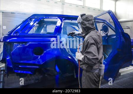 Die Fahrzeuge werden in der Lackiererei, einem Teil der Advanced Manufacturing Facility von Jaguar Land Rover in Solihull, Birmingham, lackiert. Bilddatum: Mittwoch, 15. März 2017. Bildnachweis sollte lauten: Matt Crossick/ EMPICS. Die Lackiererei nutzt 26 km Förderbänder, und eine Mischung aus Handlackierung und automatisierten Robotern lackiert jede Karosserie über einen Zeitraum von 10 Stunden. Stockfoto
