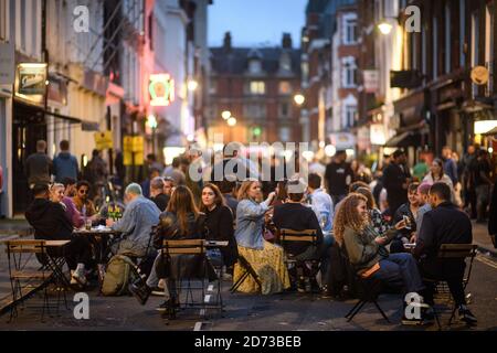 Die Menschen essen und trinken im Freien in Soho, London, da die Beschränkungen für die Sperrung des Coronavirus in ganz England gelockert werden. Viele Straßen in Soho wurden für die Nacht zur Fußgängerzone erklärt und Bars und Restaurants haben zusätzliche Sitzgelegenheiten im Freien hinzugefügt. Bilddatum: Sonntag, 5. Juli 2020. Bildnachweis sollte lauten: Matt Crossick/Empics Stockfoto