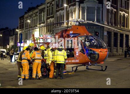 Rettungskräfte verladen einen Unfallopfer in den Londoner Air Ambulance, außerhalb der U-Bahnstation Tufnell Park im Norden Londons. Die Polizei am Tatort berichtete, dass eine Frau unter einen Zug am Bahnhof fiel und dringend ärztliche Hilfe benötigte. Stockfoto