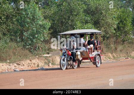 Sihanoukville, Kambodscha - 30. Dezember 2018 : typisches kambodschanisches Tuk Tuk Tuk mit chinesischen Passagieren an Bord auf einer Sandstraße in Sihanoukville, Kambodscha Stockfoto