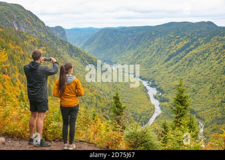 Natur Trek Wanderung paar Touristen Menschen fotografieren mit dem Telefon bei Blick auf die Berglandschaft im Herbstwald Kanada Reise, Jacques Cartier Stockfoto