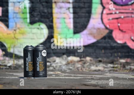 KHARKOV, UKRAINE - 16. AUGUST 2020: Gebrauchte Montana schwarze Aerosoldosen gegen Graffiti-Gemälde. MTN oder Montana-Dosen sind Hersteller von hohen Präs Stockfoto