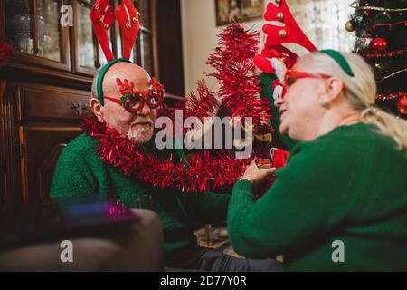 Seniorenpaar zu Hause mit einer Weihnachtsfeier auf einem Videoanruf Stockfoto