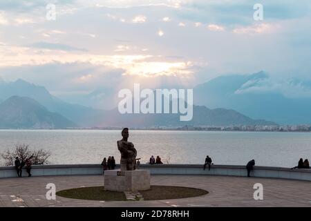 Antalya, Türkei - 22. Februar 2019: Menschen sitzen auf der Steinbrüstungsanlage auf dem Platz der Altstadt Kaleici in Antalya Stockfoto