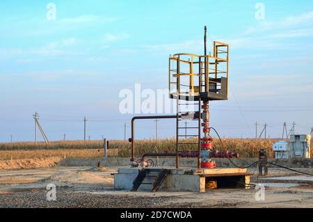 Industrierohre mit Stahlflanschen und Schrauben auf Ölfeld. Kraftstoffleitungen Ventile und Rohleitungen. Gasbohrungen entgleisen am Wüstenölfeld für fossi Stockfoto