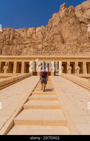 Vertikale Aufnahme eines kaukasischen Mannes, der im Totentempel der Hatschepsut, Ägypten, reist Stockfoto