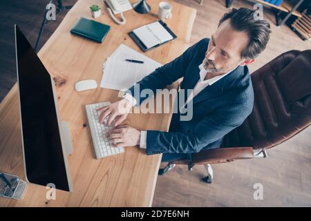 Oben über Hochwinkel-Ansicht Porträt seiner er stattlich Fokussierter beschäftigter Mann ceo Chef Chief Director qualifizierter Vertriebsleiter Sitzen im Stuhl Eingabe Bericht Stockfoto