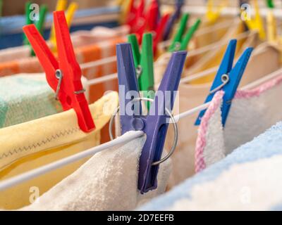 Nahaufnahme von verschiedenen Kunststoff-Wäscheklammern auf einem Wäscheständer mit Leinen. Waschkonzept. Geringe Schärfentiefe. Stockfoto
