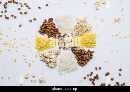 Multi-Korn-Haferbrei, Hirse Haferbrei Reis und Buchweizen auf weißem Hintergrund, Schneeflocke aus Getreide, Blume aus Getreide Stockfoto