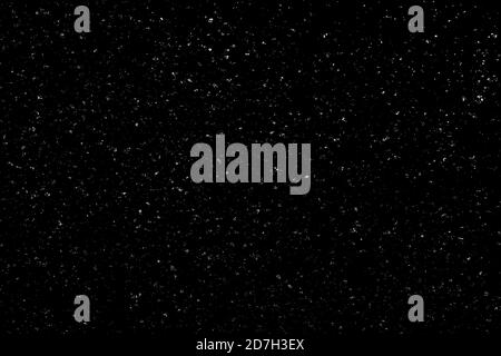 Chaotisches weißes Bokeh auf schwarzem Hintergrund. Lichtflecken Textur, Abstraktion. Fallender Schnee. Sternenhimmel. Stockfoto