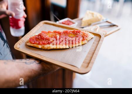 Kellner serviert Tomatensandwich im Café Stockfoto