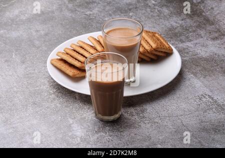 Schneiden Chai, traditionelle Desi Roadside Tee von indien mit Keksen. Stockfoto