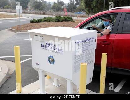 Ein Wähler legt seinen Stimmzettel an einer offiziellen Abgabestelle außerhalb des Wahlbüros ab, eine Reihe von Abgabestellen wurden um Santa Barbara herum platziert. Stockfoto