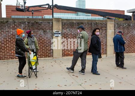 Brooklyn, NY - 24. Oktober 2020. Eine Reihe von Leuten, die gerne wählen wollten, streckte sich 0.6 Meilen (1 km) eine halbe Stunde nach der Eröffnung der Umfragen am ersten Tag der frühen Abstimmung in New York. Die Türen am frühen Wahlort am Brooklyn College in der Midwood Nachbarschaft öffneten sich für die Wähler um 10:00 UHR, und ein Umfragearbeiter berichtete, dass die erste Person, die an die Türen kam, um 4:30 Uhr an diesem Morgen. Einige Leute brachten Klappstühle, einige brachten ihre Kinder, und alle schienen resigniert zu warten, solange es dauerte. Die Leute warten auf der Bedford Avenue, noy weit weg vom Wahllokal. Stockfoto