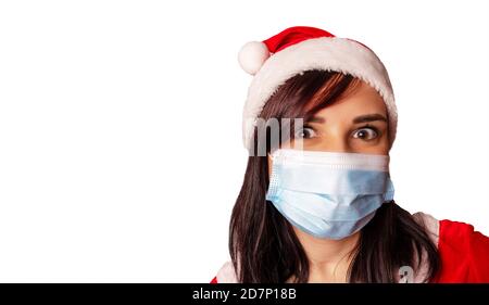 Junge Frau in medizinischer Maske und Weihnachtsmann Anzug auf weißem Hintergrund. Nahaufnahme der Frau in Weihnachtshut und Schutzmaske.Konzept der Safe Stockfoto