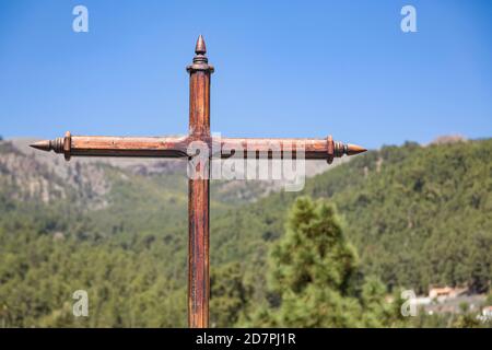 Christliches Holzkreuz, Kruzifix, in einer Landschaft von Bäumen und Bergen auf Teneriffa, Kanarische Inseln. Christentum und Religion Konzept Stockfoto