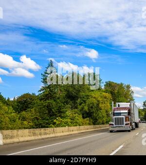 Industrie-Profi Big Rig klassische Langstrecke braun semi-Truck Traktor Transport von gewerblichen Fracht in Kühlschrank Sattelauflieger läuft für Feinkostgeschäft Stockfoto