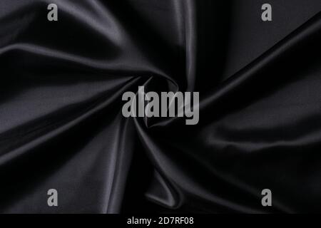 Luxuriöse schwarze Stoff Hintergrund. Glatte elegante schwarze Seide oder Satin Textur Hintergrund. Stockfoto