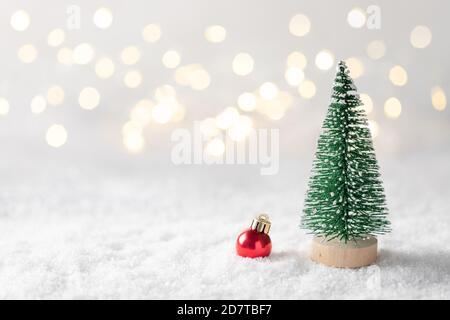 Weihnachtsbaum und Dekoration gegen verschwommenes Licht auf weißem Hintergrund. Stockfoto