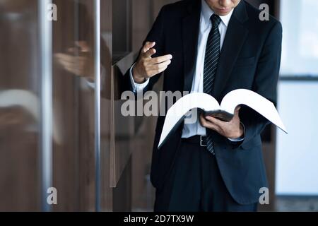 Zugeschnittenes Bild des Rechtsanwalts, der das Buch liest Stockfoto