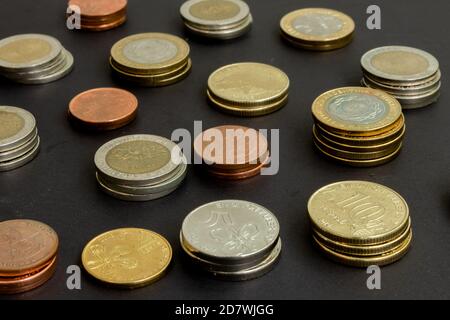 Verschiedene argentinische Münzen gestapelt. Haufen Geld. Metallmünzen Textur. Verschiedene Bezeichnungen. Stockfoto