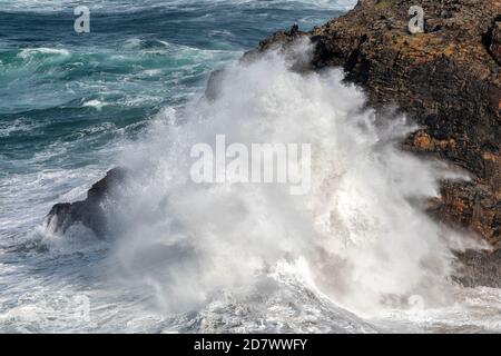 Zwei Fischer trotzen riesigen Wellen auf Klippen in der Nähe von Perranporth Cornwall als starke Winde schlagen den Südwesten der Vereinigtes Königreich Stockfoto