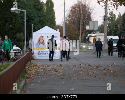 Dnipro, Ukraine - 23. Oktober 2020: Agitatoren verteilen Flugblätter an Wahlkampfwürfeln vor den Wahlen der lokalen Abgeordneten. Lady mit gedruckter Promotion Stockfoto