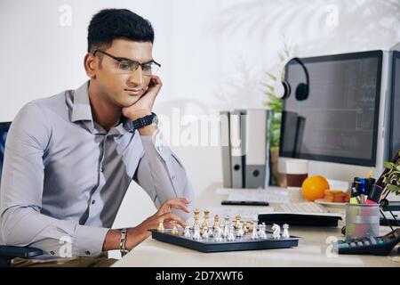 Nachdenklicher Mann, der Schach spielt Stockfoto