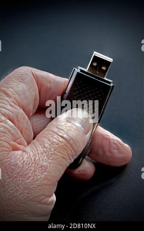 Ältere Hand mit Falten halten Memory Stick Stockfoto