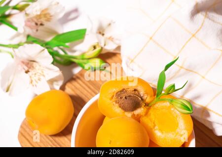 Zusammensetzung von frischen Aprikosen für kulinarische Dessertklasse oder Tapete. Sommerliche Obsternte. Gesunde vegane Ernährung. Rohrezept Stockfoto