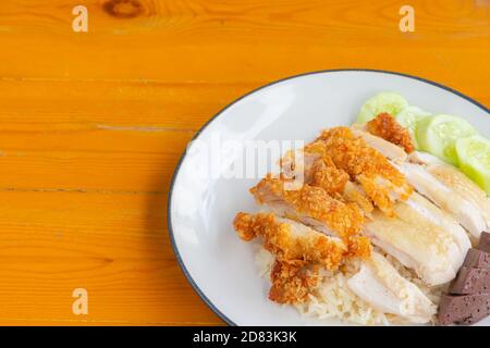 Nahaufnahme von gebratenem und gedünstetem Hühnerreis mit Gurke Auf dem Holztisch Stockfoto