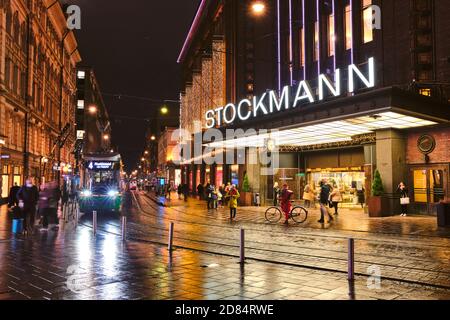 Helsinki, Finnland - 26. Oktober 2020: Die Straßenbahnen fahren auf der Aleksanterinkatu Straße. Der regnerische Herbstabend. Stockfoto