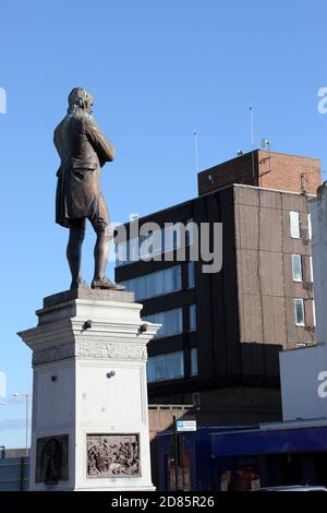 Ayr, Ayrshire, Schottland, Großbritannien. Die Statue des berühmten Dichters Robert Burns von Ayrshire sitzt auf einem Sockel am südlichen Ende der Stadt in einem Gebiet, das als Burns Statue Square bekannt ist.zweimal im Jahr werden Kränze an der Statue gelegt, um Geburtstag und Tod zu feiern. Die Statue blickt auf das Burns House, die Verwaltungsbüros des South Ayrshire Council, die 2021 abgerissen wurden Stockfoto