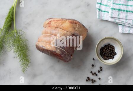 Roh-Rindfleisch-Joint und schwarze Pfefferkörner Stockfoto