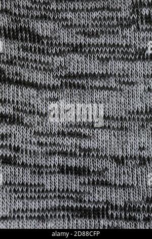 Dunkelgrauer Grau- oder Melange-Stoff-Textur-Hintergrund. Stockfoto