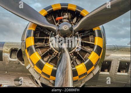 9-Zylinder-Verbrennungsmotor mit gelbem, schwarzem Quadrat-Muster. Neun Kammer, luftgekühlter Radialmotor mit Propeller Nahaufnahme auf schweren Militärbomber Stockfoto