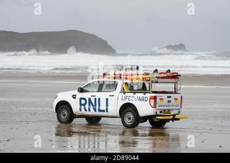 Newquay, Cornwall, Großbritannien. Oktober 2020. Wetter in Großbritannien. Ein RNLI-Rettungsschwimmer patrouilliert am Fistral-Strand, während große Wellen von den Überresten des Hurrikans Epsilon in Newquay in Cornwall an einem Tag starker böiger Winde während der Schulferien an Land stürmen. Bild: Graham Hunt/Alamy Live News Stockfoto