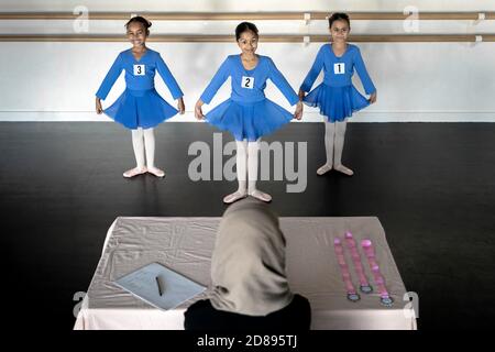London, Großbritannien. Oktober 2020. Weltballetttag: Muslimische Ballettschule. Die jungen Studenten Elyana, Hafsah und Safa (L-R, alle 7 Jahre) von Grace & Poise Academy bereiten sich auf ihre ersten Ballettprüfungen des Jahres 2 vor, die ursprünglich wegen des Covid19 vom Juli verschoben wurden. Gegründet im Januar 2019 von Maisie Alexandra Byers, Absolventin der Royal Academy of Dance, und Dr. Sajedah Shabib, Geschäftsführerin, Die Grace & Poise Academy ist die weltweit erste Ballettschule, die Ballett in die muslimische Gemeinschaft bringt, mit dem Ziel, jungen Ballettstudenten unterstützende und integrative Räume zu bieten. Kredit: Guy Corbishley/Alamy Live Nachrichten Stockfoto