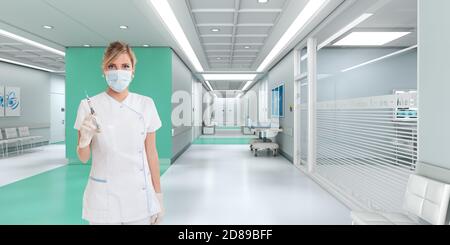 Medizinische Mitarbeiterin, die eine Spritze in einem Krankenhaus hält Stockfoto